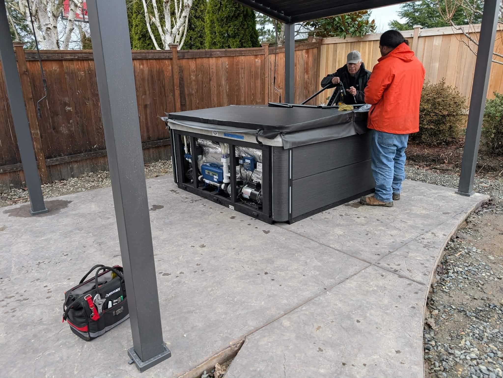 Black Pine service technician repairing a hot tub on site